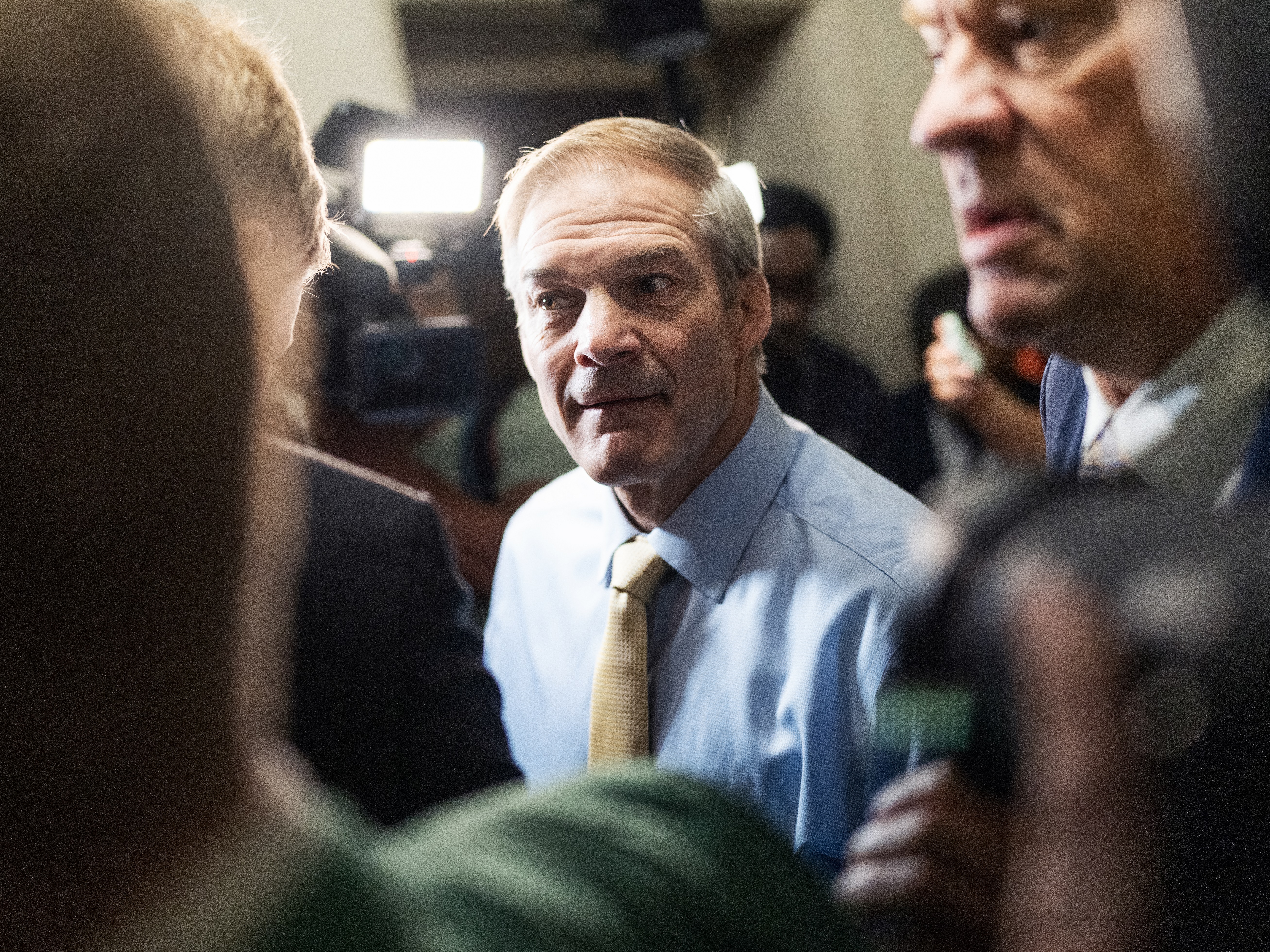 caption: Reps. Jim Jordan, R-Ohio, and Russ Fulcher, R-Idaho, right, arrive to a House GOP conference meeting on Friday morning.