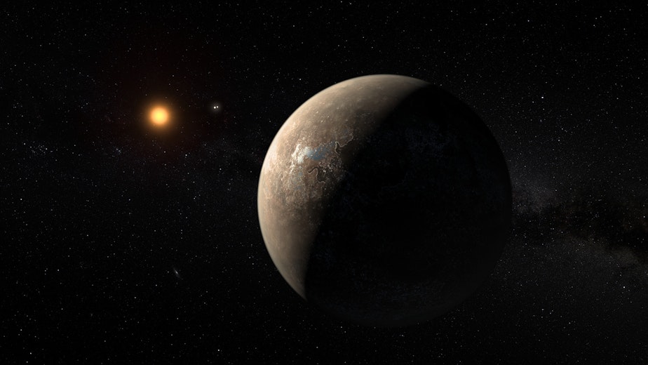 caption: An artist's rendering shows what Proxima b and its star, Proxima Centauri, might look like.