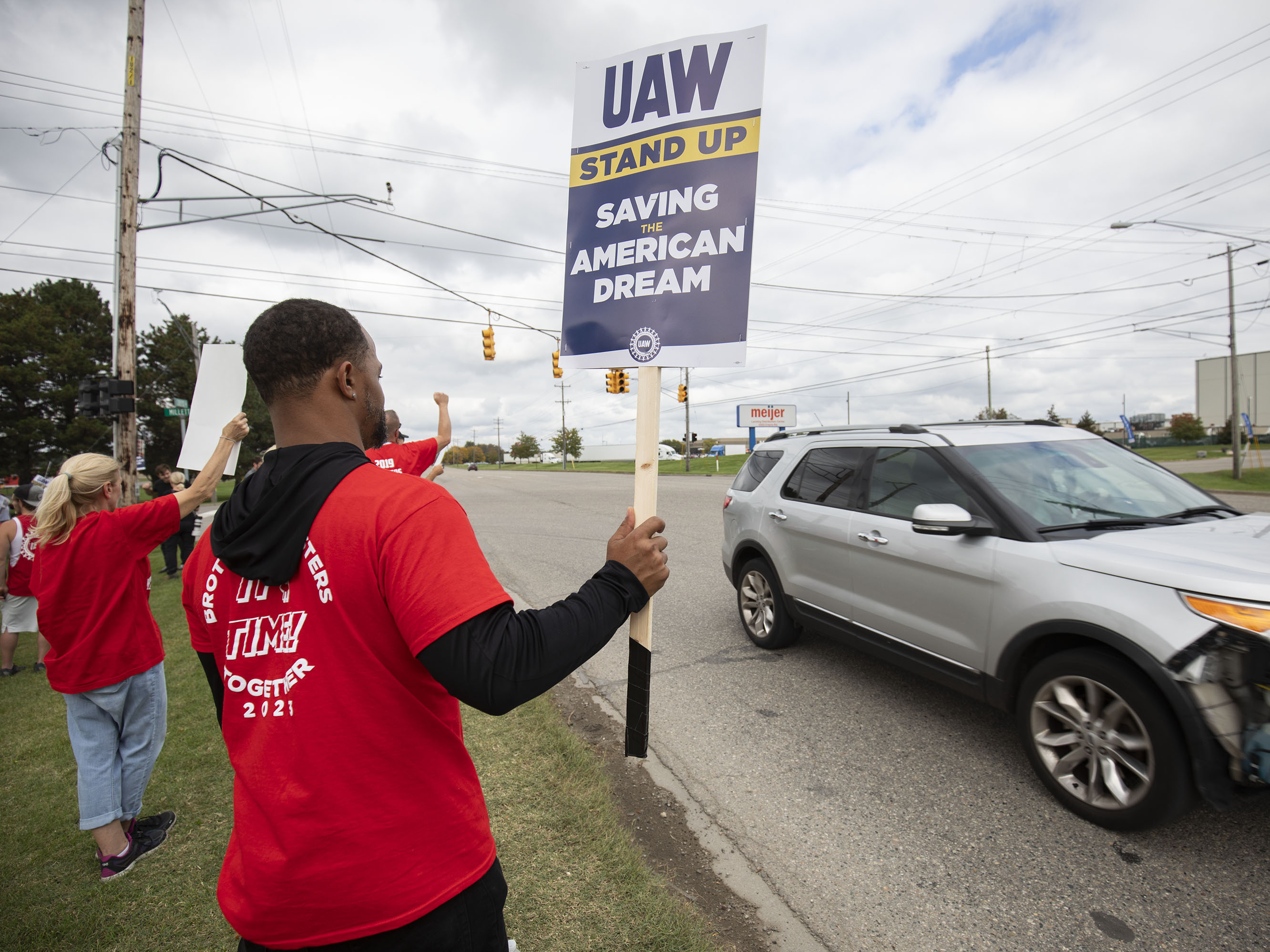 caption: United Auto Workers members strike the General Motors Lansing Delta Assembly Plant on September 29, 2023 in Lansing, Michigan. xx% of GM workers have so far voted xx on ratifying the tentative contract agreement.