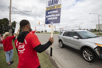caption: United Auto Workers members strike the General Motors Lansing Delta Assembly Plant on September 29, 2023 in Lansing, Michigan. xx% of GM workers have so far voted xx on ratifying the tentative contract agreement.