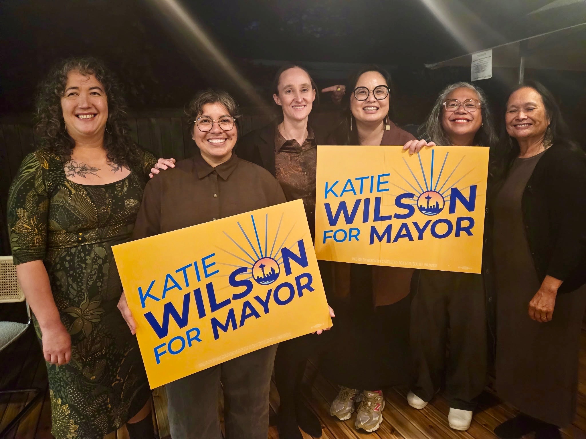 caption: From left, Mijo Lee, Jessica Ramirez, Katie Wilson, Lisa Chen, Angela Garbes, and Cindy Domingo pose for a photo during a fundraiser for Wilson, who is running for Seattle mayor, in 2025.