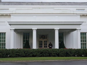 caption: The West Wing of the White House on July 5, 2023. Tech executives are meeting with top Biden administration officials on Tuesday to agree to voluntary measures to reduce risks posed by AI.