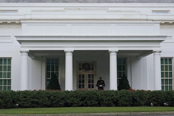 caption: The West Wing of the White House on July 5, 2023. Tech executives are meeting with top Biden administration officials on Tuesday to agree to voluntary measures to reduce risks posed by AI.