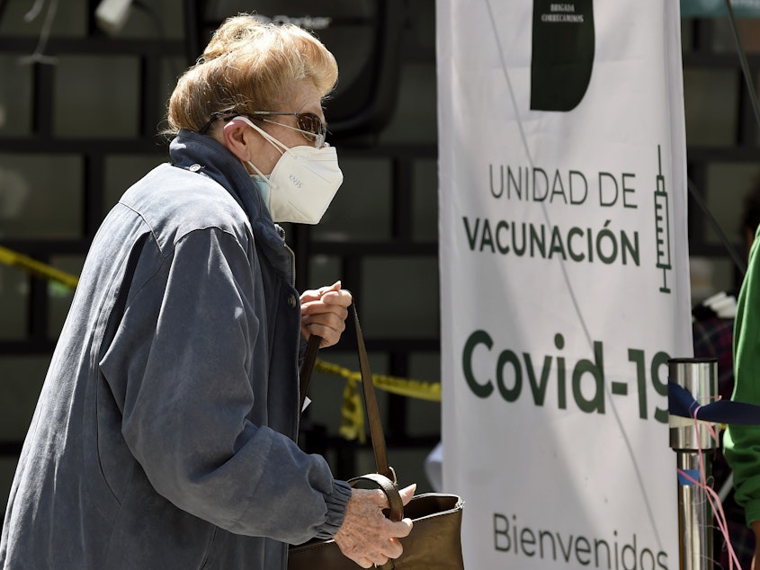 caption: A woman lines up to receive the AstraZeneca vaccine in Mexico City on Feb. 17.
