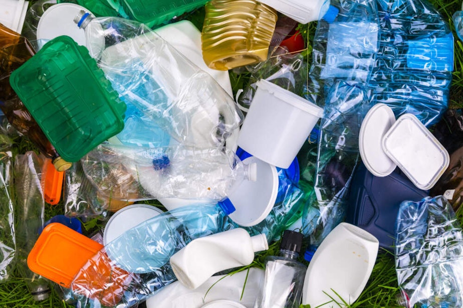 caption: Various types of plastic trash on the grass. (Anton Petrus/Getty Images)