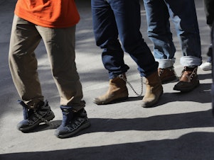 caption: Unauthorized immigrants leave a court in shackles in McAllen, Texas. More than 40,000 immigration court hearings have been canceled since the government shut down.