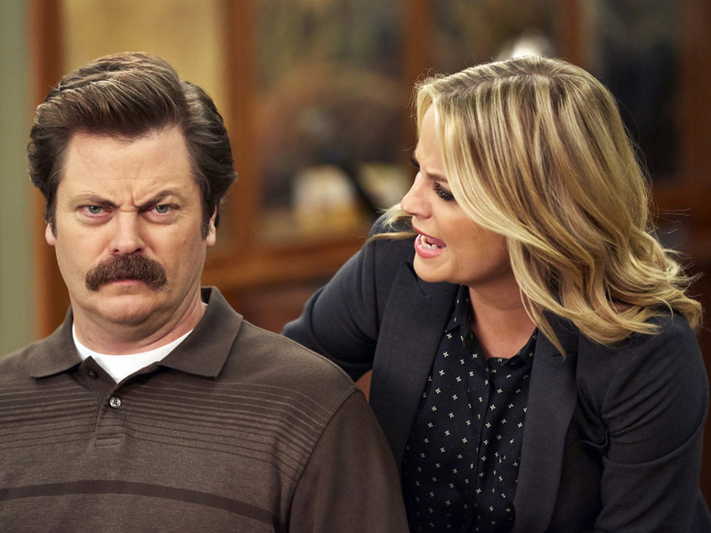 caption: Nick Offerman and Amy Poehler would never breathe on each other like this (an earlier moment in the series) in the new <em>Parks and Recreation </em>special, but at least they can talk on video.