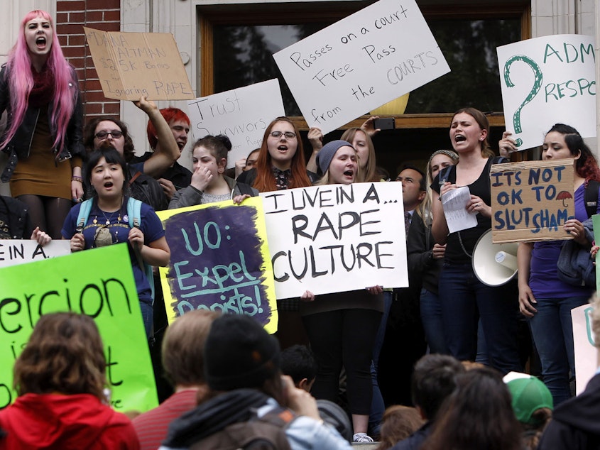 caption: University of Oregon students and staff protest on campus in Eugene, Ore. in May of 2014, against sexual violence in the wake of allegations of rape brought against three UO basketball players by a fellow student.