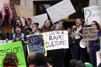caption: University of Oregon students and staff protest on campus in Eugene, Ore. in May of 2014, against sexual violence in the wake of allegations of rape brought against three UO basketball players by a fellow student.