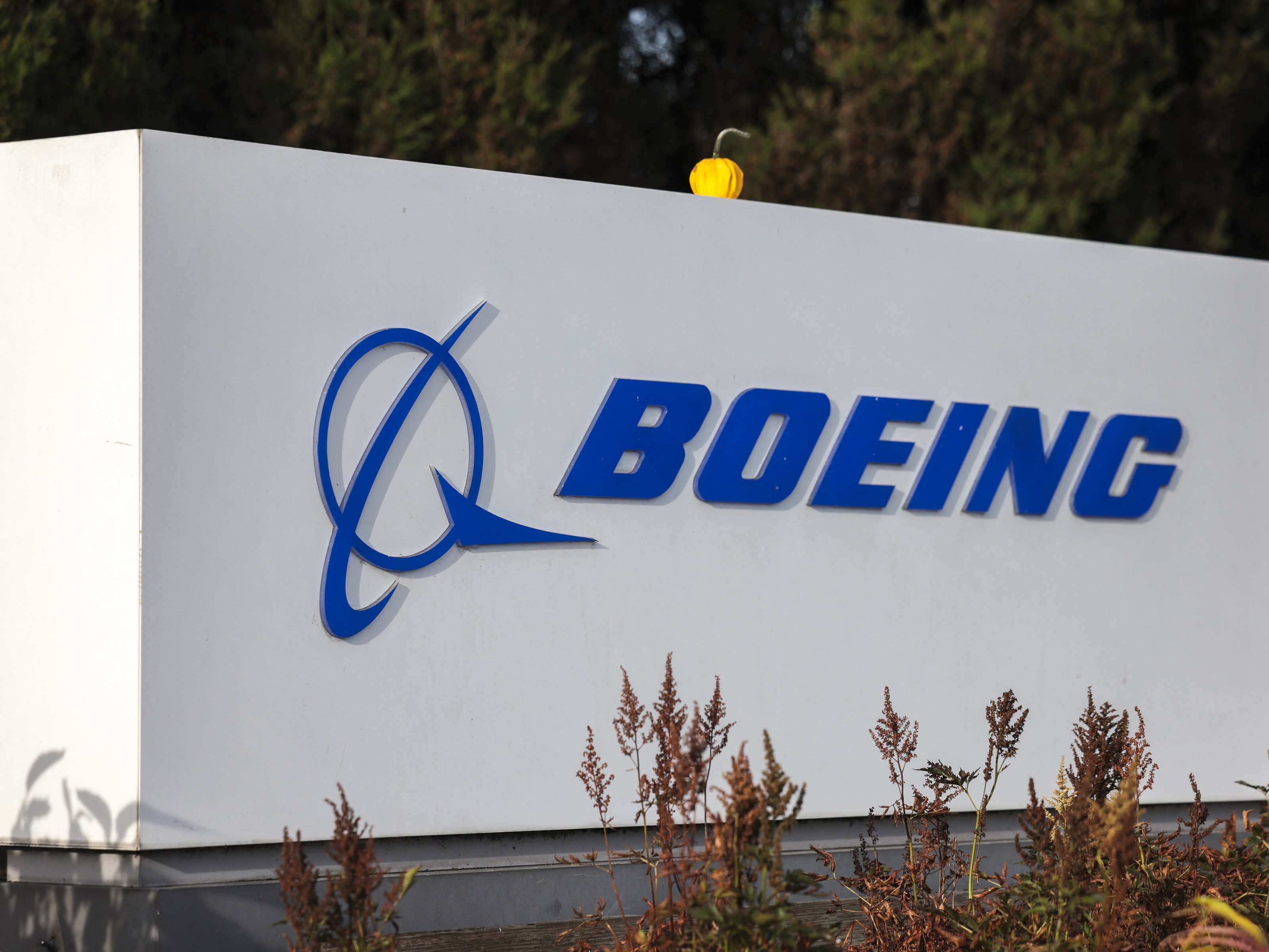 caption: A Boeing sign is pictured outside the Renton Production Facility in Renton, Wash., on Nov. 3, 2024.