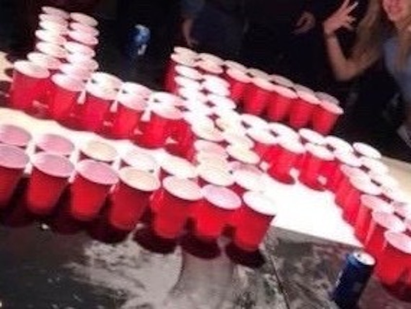 caption: This image from Twitter shows red plastic cups arranged in a swastika shape at a party reportedly attended by Newport Beach students.