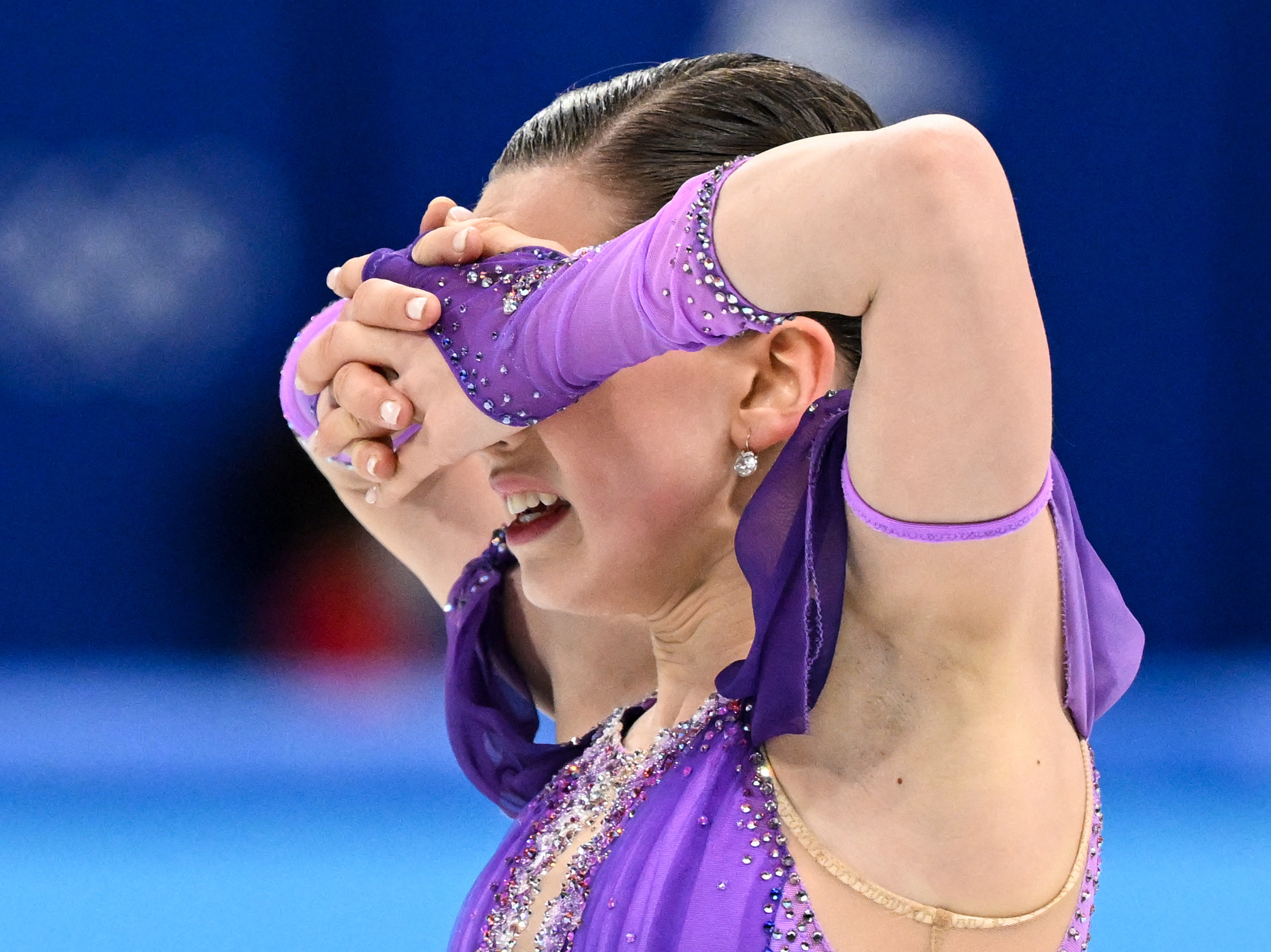 caption: Russia's Kamila Valieva reacts after competing in the women's single skating short program at the Beijing 2022 Winter Olympic Games.