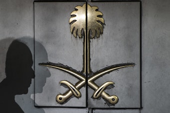 caption: The shadow of a security guard rests atop the front door of the Saudi consulate Friday in Istanbul. Journalist Jamal Khashoggi vanished after visiting the building earlier this month, and simmering international suspicion puts the Saudi government behind his murder.