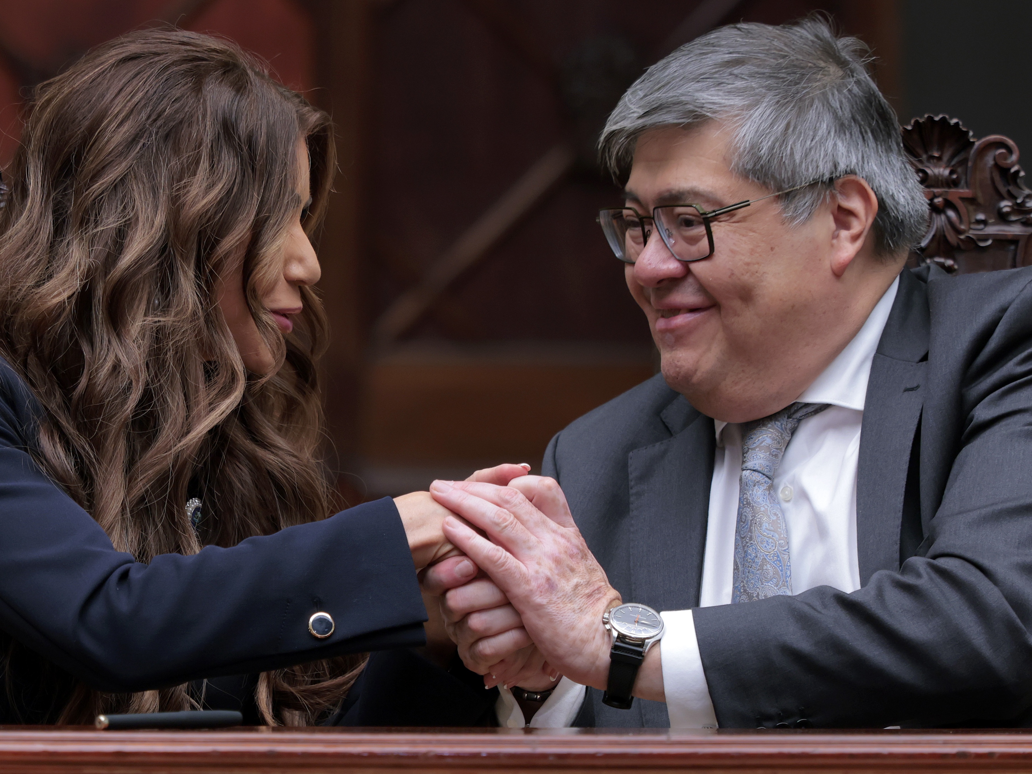 caption: Homeland Security Secretary Kristi Noem and Guatemalan Minister of Governance Francisco Jimenez shake hands after signing a memorandum of understanding on a joint security program agreement at the Palacio Nacional de la Cultura on June 26 in Guatemala City, Guatemala.