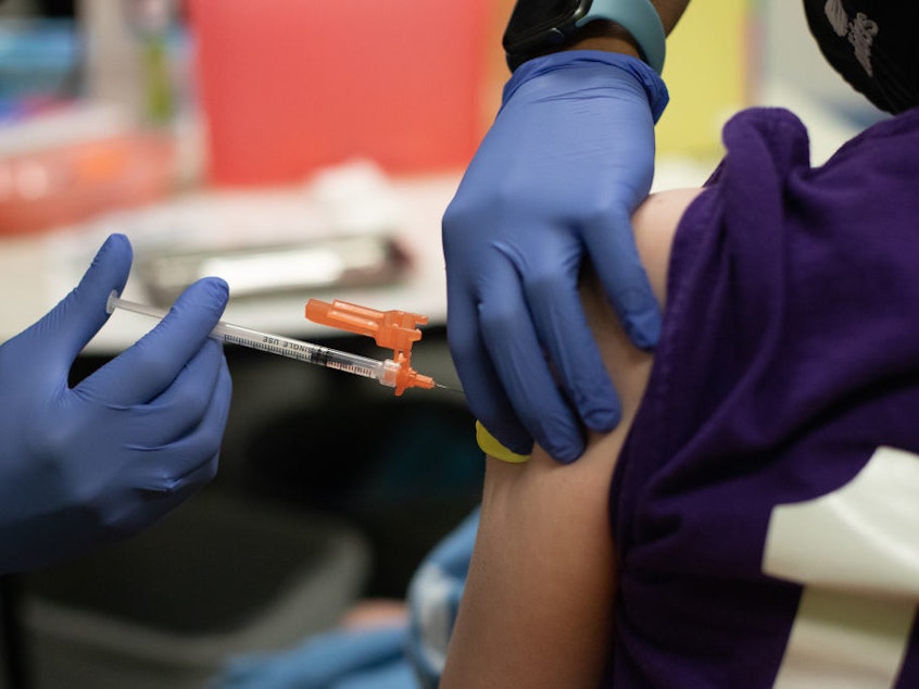 caption: A health care worker administers a dose of the Pfizer-BioNTech COVID-19 vaccine to a child at a pediatrician's office in Bingham Farms, Michigan. Federal agencies are considering whether to start giving the vaccine to children ages 5 to 11 in the near future.