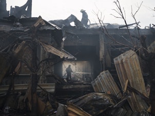 caption: <strong>April 11:</strong> Firefighters work to extinguish a fire resulting from a Russian attack at a house in Kharkiv, in eastern Ukraine.