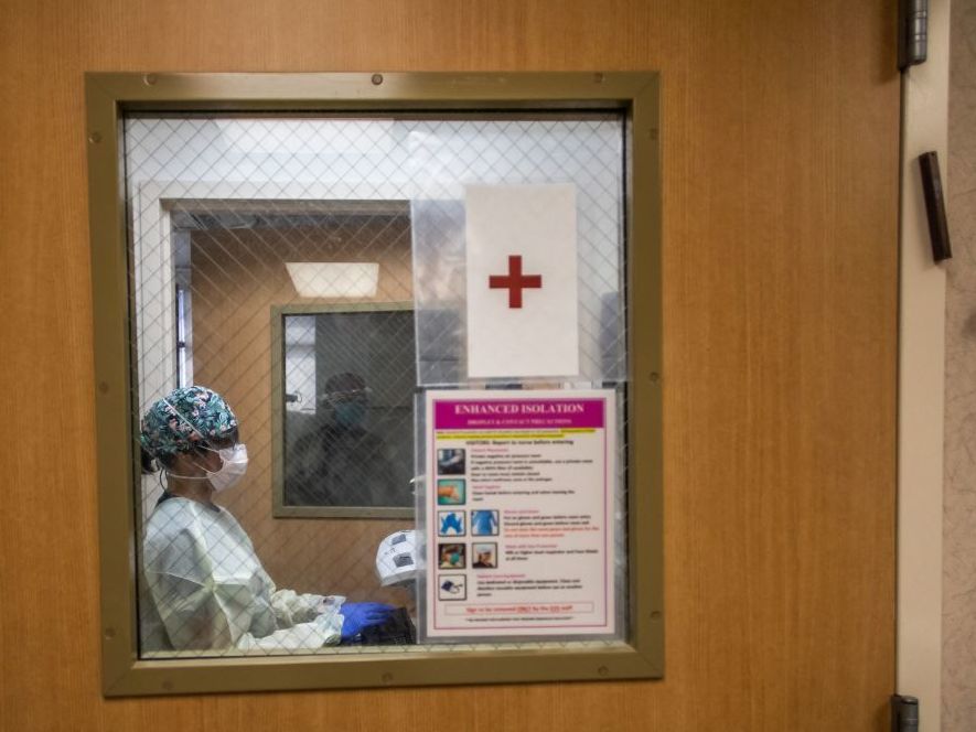 caption: Registered nurse Christie Lindog works at the cardiovascular intensive care unit at Providence Cedars-Sinai Tarzana Medical Center in Tarzana, Calif., on Sept. 2.