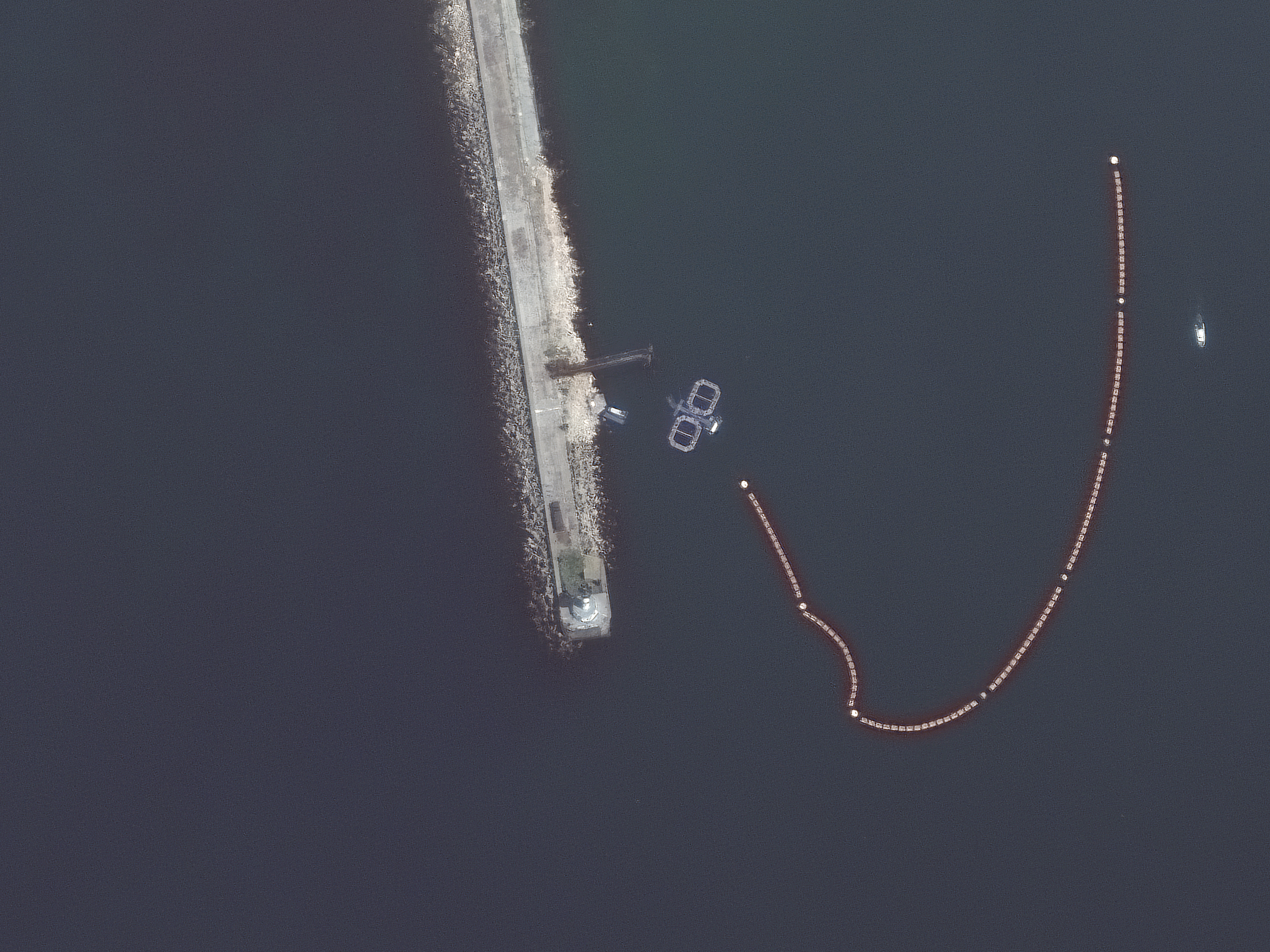 caption: Satellite imagery captured by Maxar Technologies on Friday appears to show dolphin pens at the entrance to Sevastopol Harbor. The naval base there is important to the Russian military because of its proximity to the Crimean peninsula.