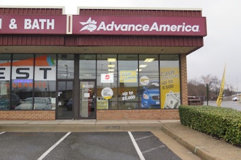 caption: Ads promise cash in the form of payday loans at an Advance America storefront in Springfield, Va. The Consumer Financial Protection Bureau is seeking to rescind a proposed rule to safeguard borrowers from payday lenders.