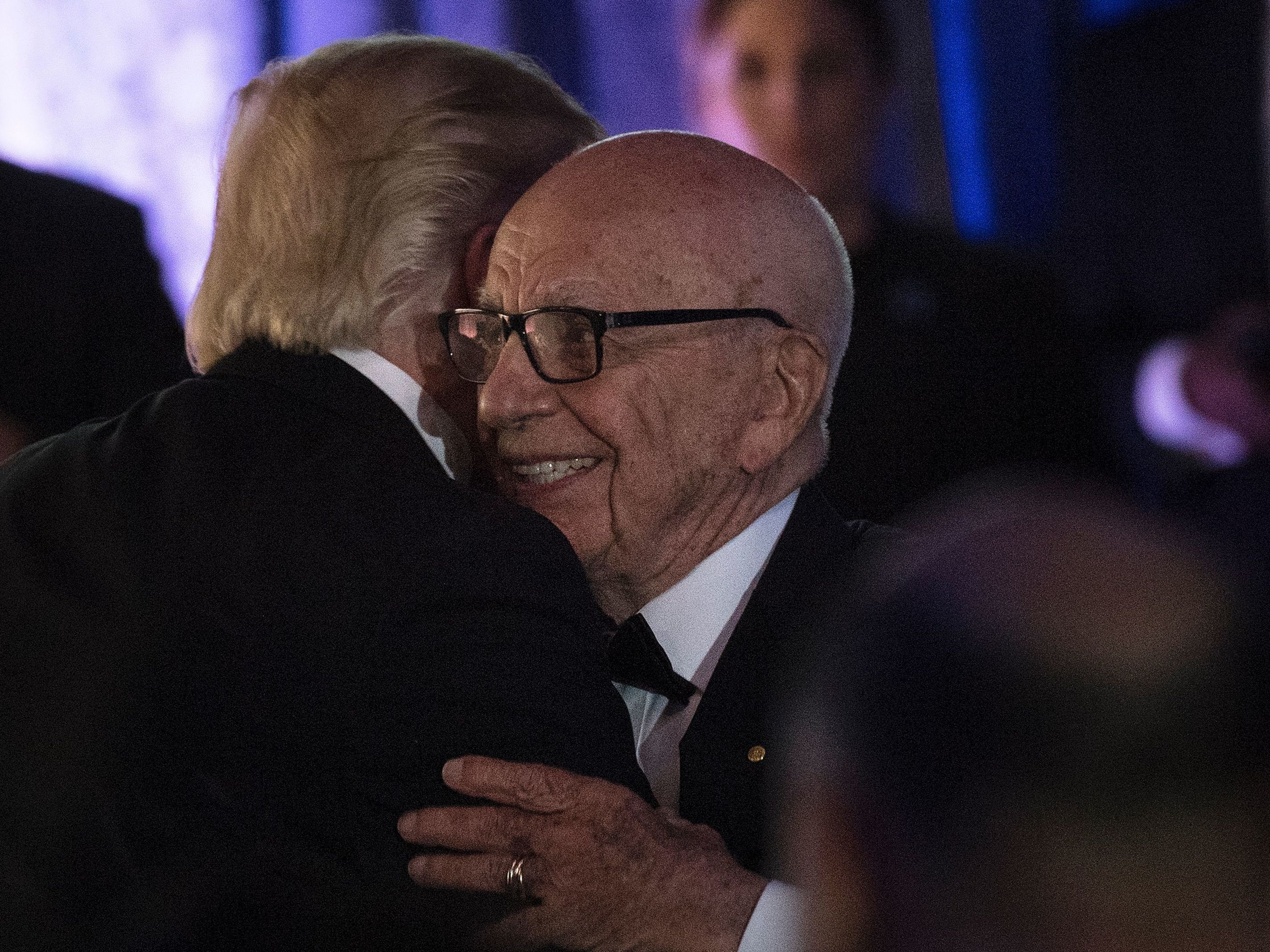 caption: President Trump embraces Rupert Murdoch, co-chairman of Fox Corp., at a dinner in 2017. Once close, Trump is now angry at Murdoch's Fox News over its election coverage.