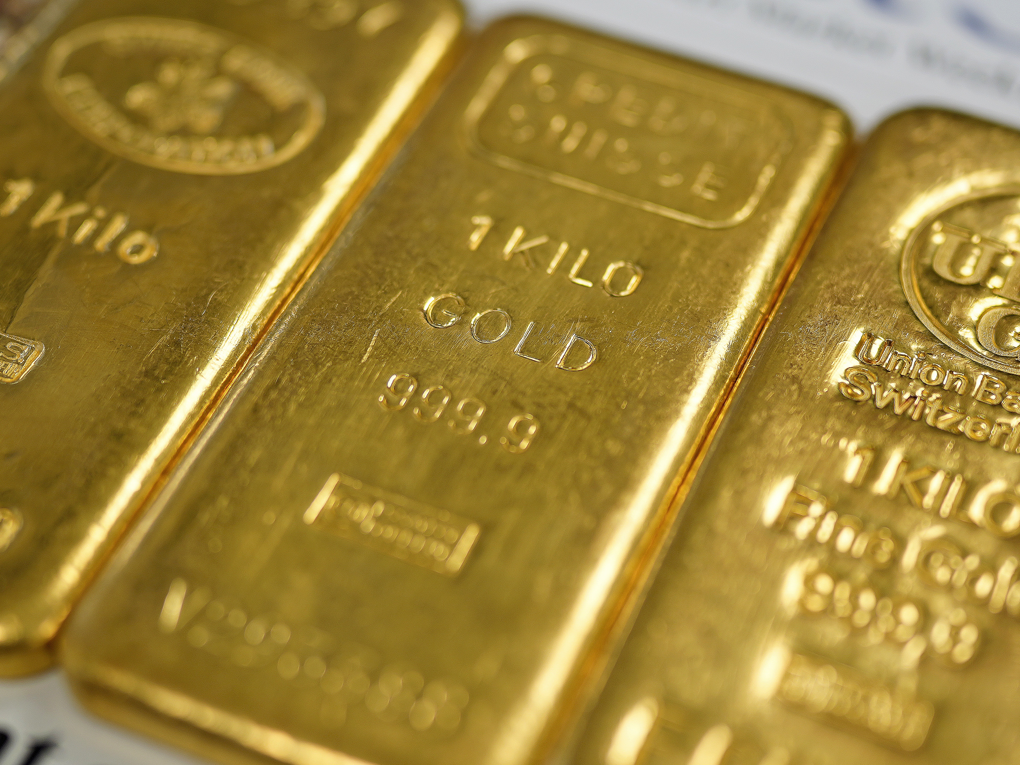 caption: Gold prices have been hitting record highs. Pictured are gold bullion bars in Birmingham, England on Dec. 13, 2023.