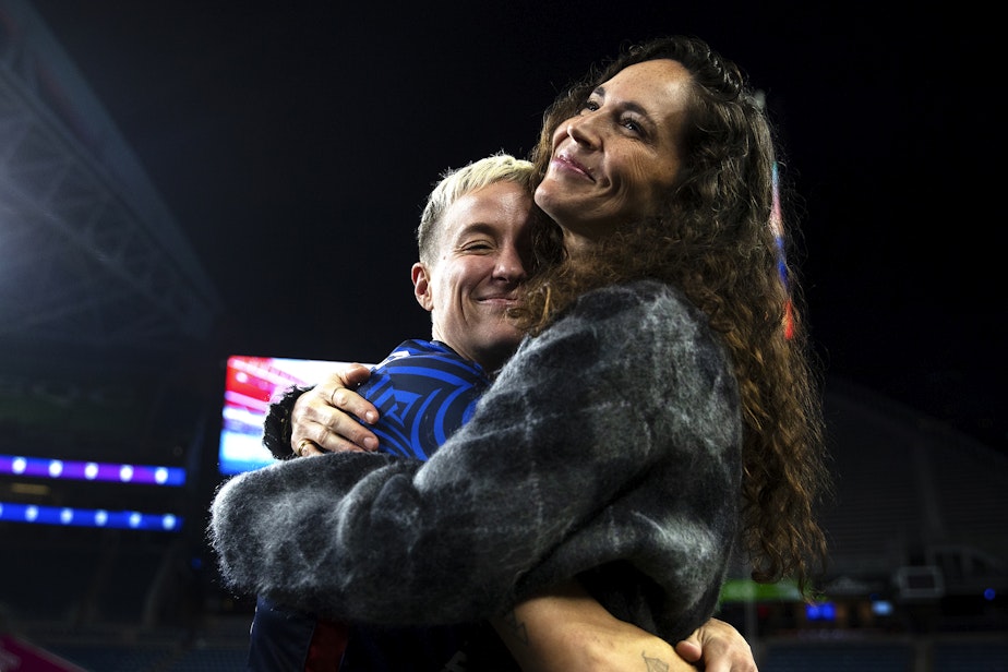 caption: Megan Rapinoe and Sue Bird share a hug following Rapinoe’s last regular-season NWSL home game against the Washington Spirit on Friday, October 6, 2023, at Lumen Field in Seattle.  