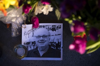 caption: Flowers, notes and pictures line the entrance of Leschi Market in memory of co-owner Steve Shulman on Monday, March 23, 2020, in Seattle. Shulman passed away on March 18 after testing positive for the coronavirus. 