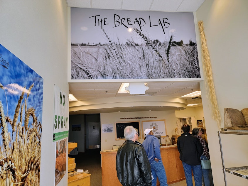 caption: The line to buy fresh bread and treats stretches out the door during rare pop-up sales at the Breadlab on Saturday, March 29, 2025.