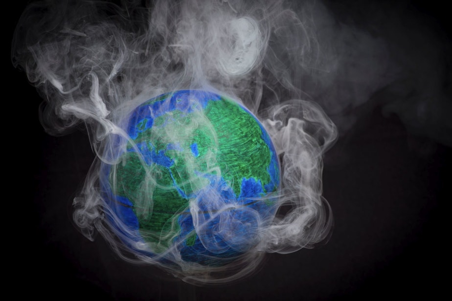 caption: A picture taken on November 10, 2015 shows a small globe surrounded by smoke to illustrate global warming. (Lionel Bonaventure/AFP/Getty Images)