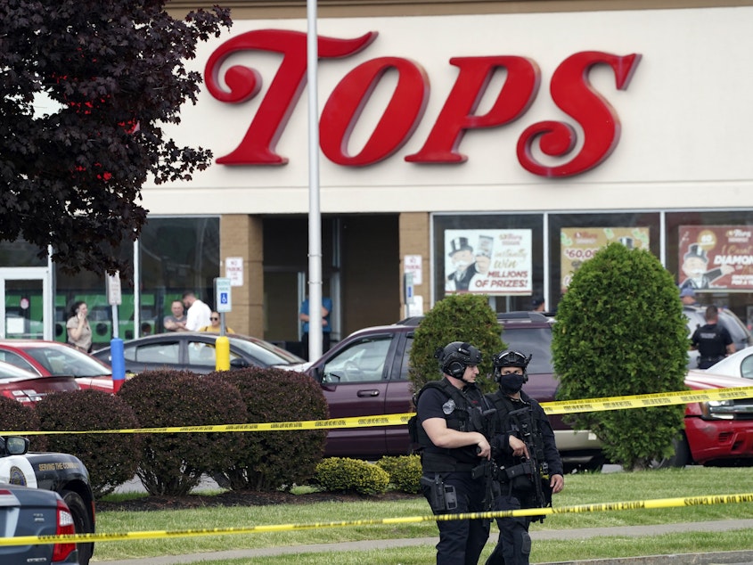 caption: Police secure an area around a Buffalo, N.Y., supermarket where 10 people were killed in a shooting on May 14, 2022.