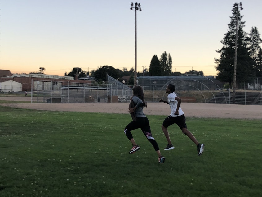 caption: Hamda Hassan runs with her little brother, a freshman at Franklin High School. She convinced him to join the cross country team so that he would have a community in his first year of high school.