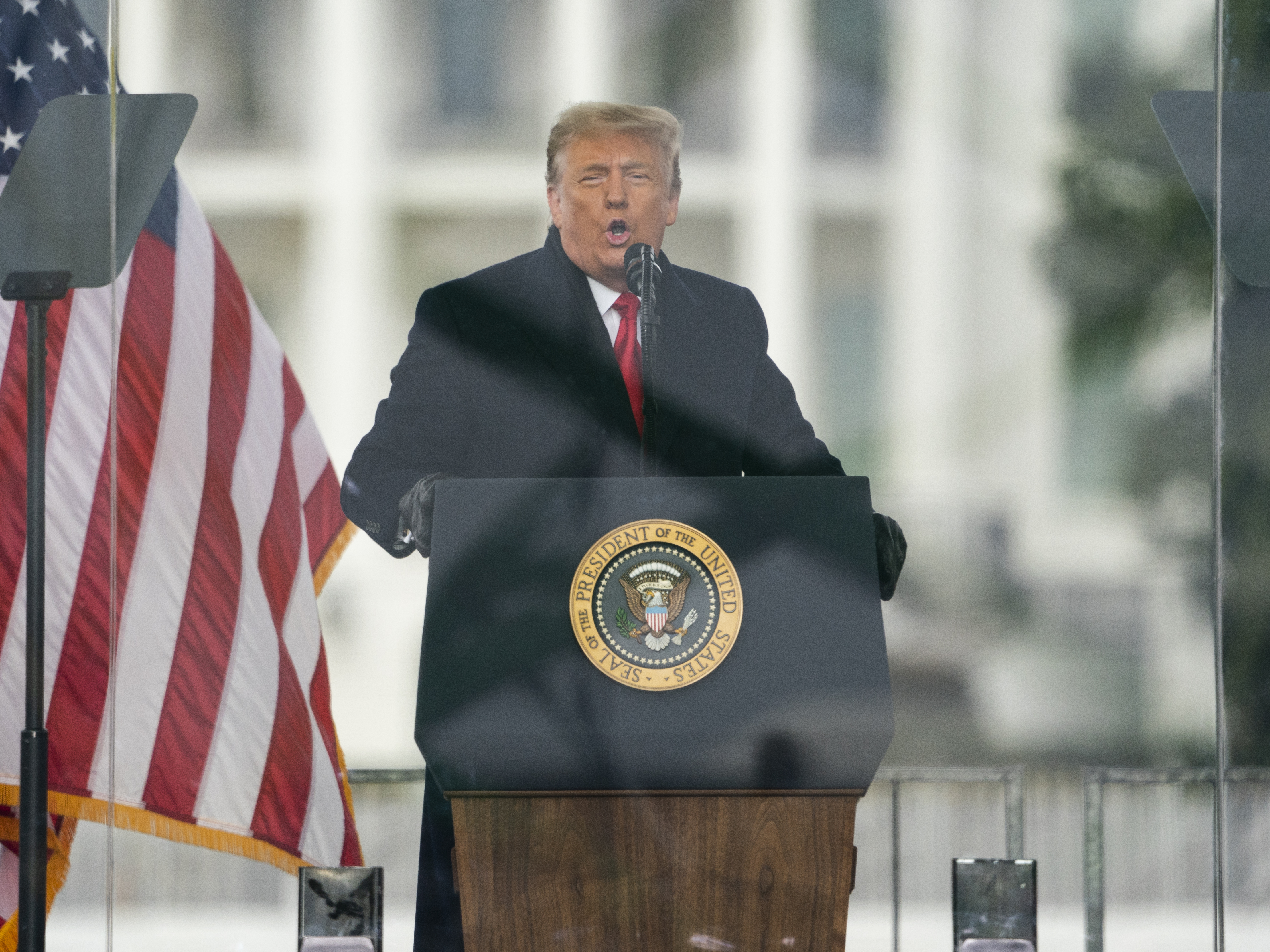 caption: Then-President Donald Trump speaks during a rally Jan. 6, ahead of the riot at the Capitol. Trump is trying to stop the release of records to a House panel investigating the riot.