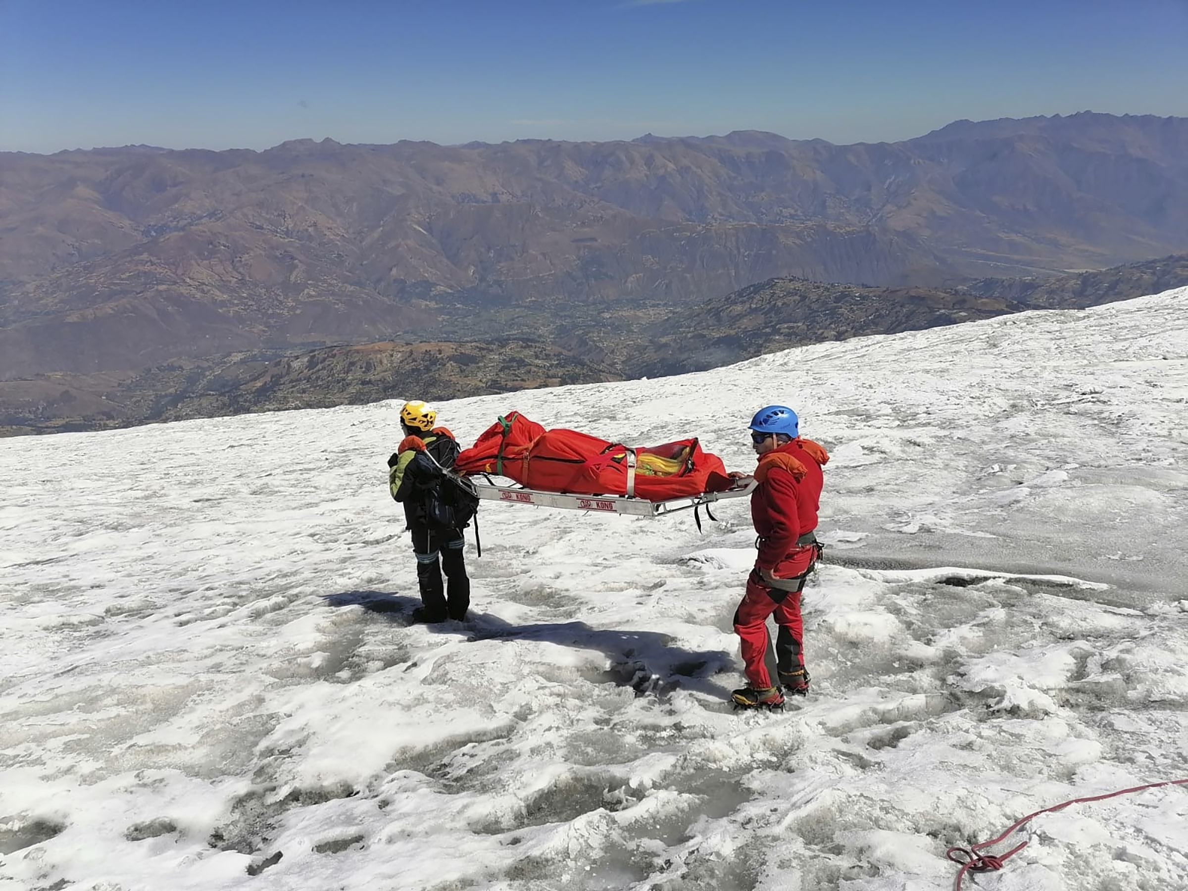 caption: Police carry a body that they identify as U.S. mountain climber Bill Stampfl on Huascaran mountain in Huaraz, Peru, on Friday. Peruvian authorities said they found the mummified body of Stampfl, who died 22 years ago along with two other American climbers after they were trapped in an avalanche while trying to climb Peru's highest peak.
