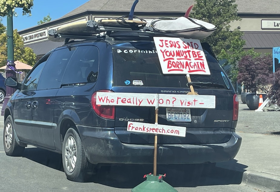 caption: One of the signs on a van parked in the middle of Sequim asks "who really won?" over six months after the last presidential election.    