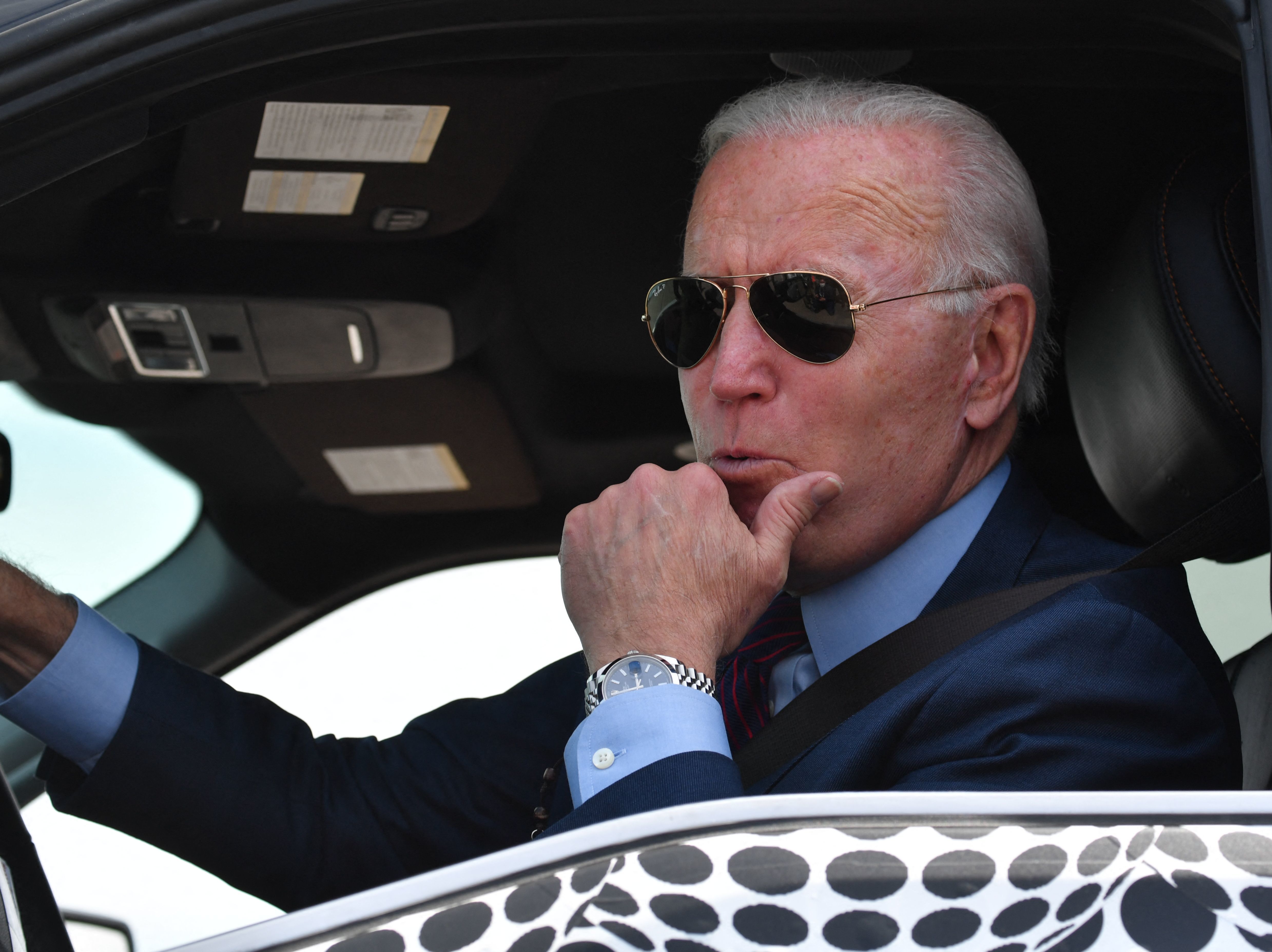 caption: President Biden drives the new electric Ford F-150 Lightning at the Ford Dearborn Development Center in Dearborn, Mich., on Tuesday. Ford is set to unveil the pickup truck at a formal ceremony on Wednesday night.