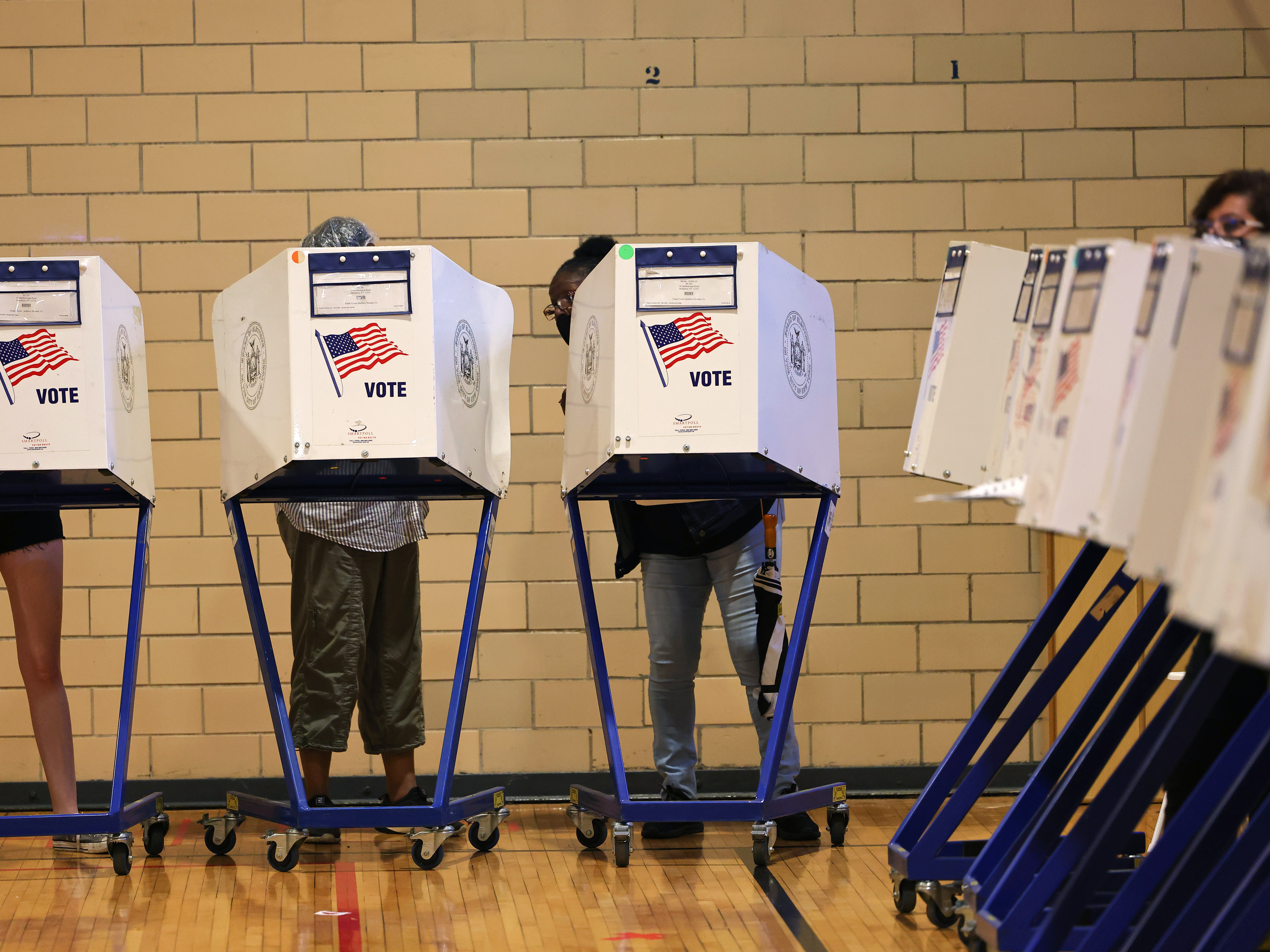 caption: People vote during the Primary Election Day at P.S. 249 The Caton School on June 22 in the Flatbush neighborhood of Brooklyn borough in New York City.