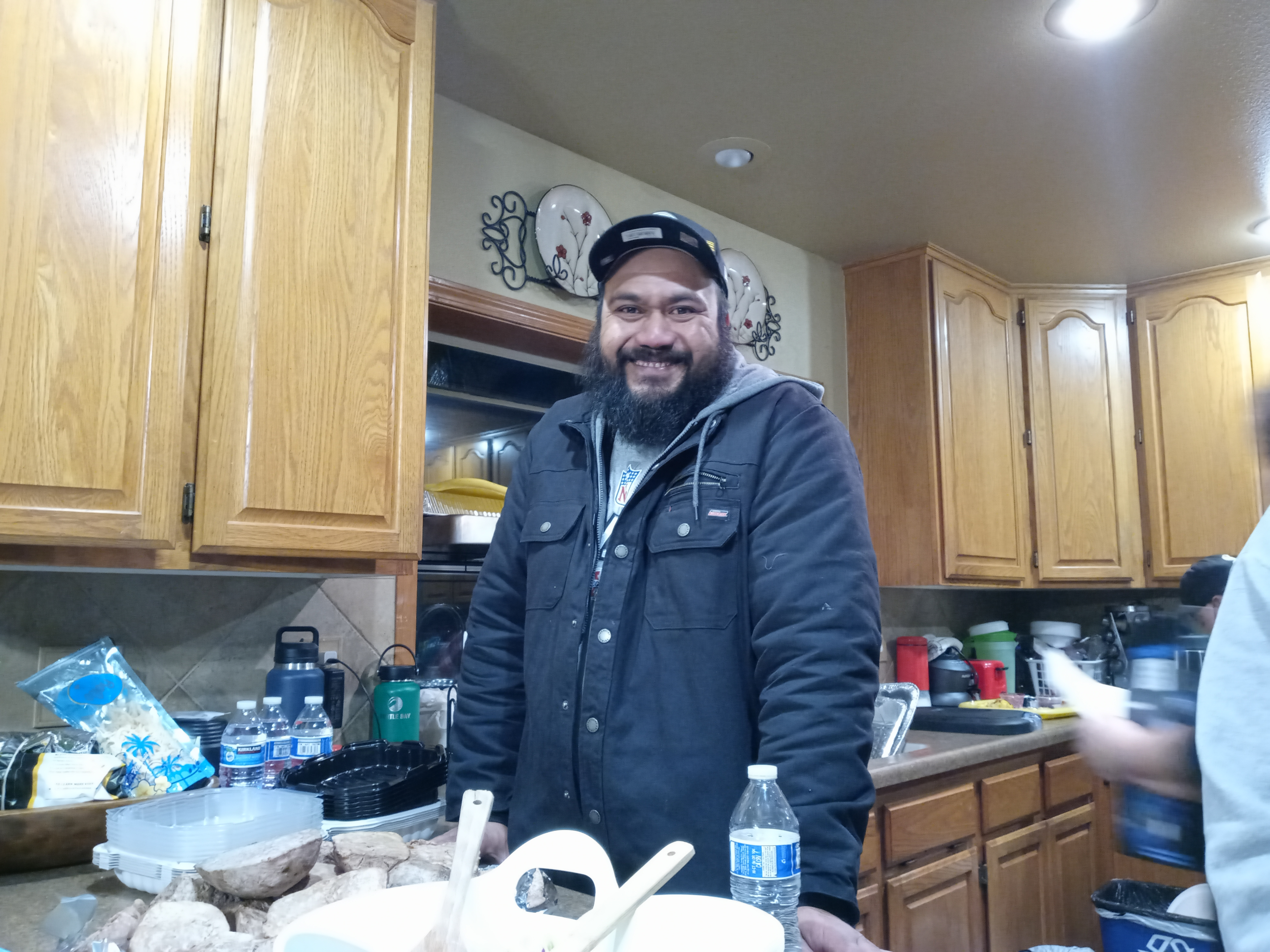 caption: Failelei Papatu in the kitchen on Christmas Day, 2021.