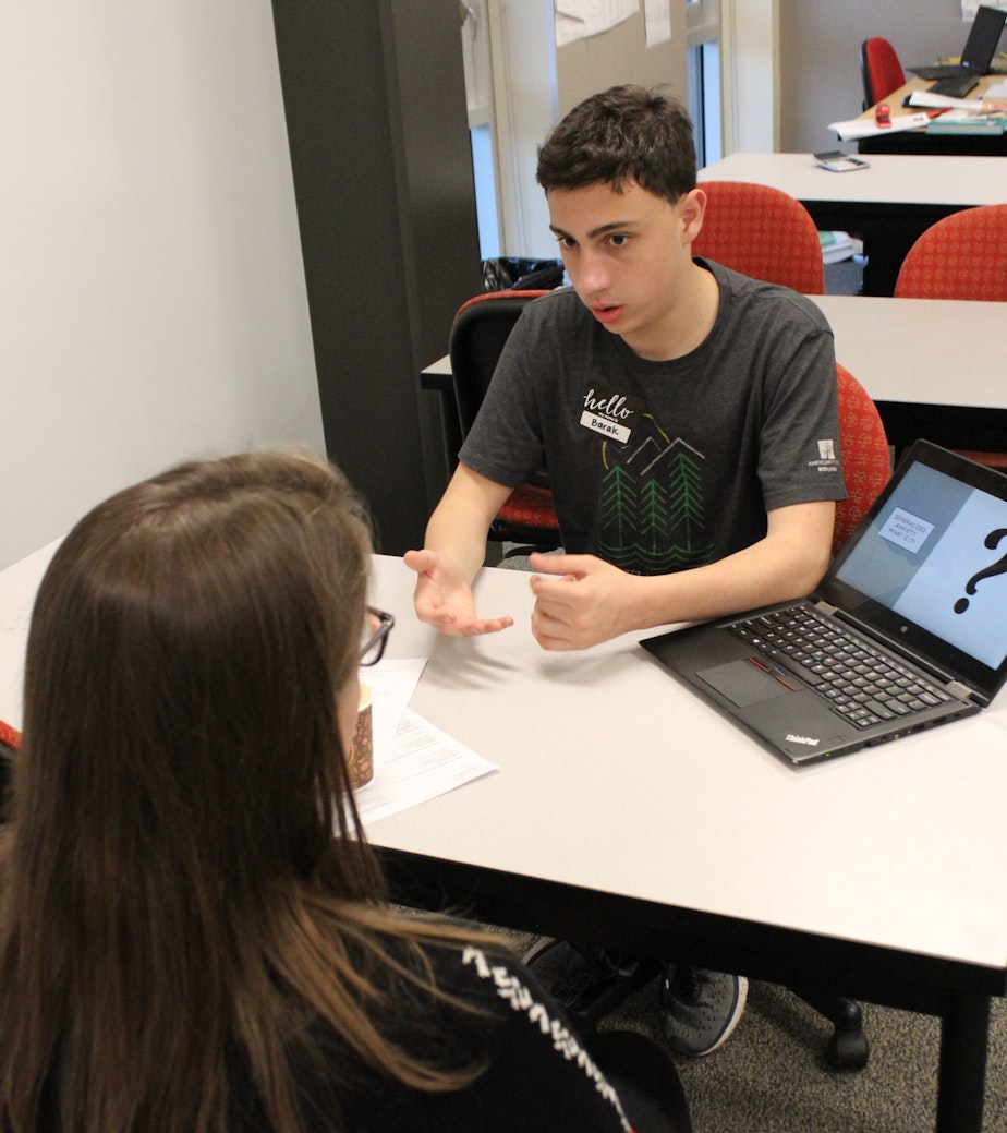 caption: Barak Horowitz, a 10th grader at Sammamish High School in Bellevue, speaks with a visitor about anxiety disorder at the school's recent Health and Wellness Night 