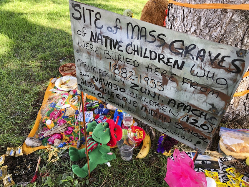 caption: A makeshift memorial for the dozens of Indigenous children who died more than a century ago while attending a boarding school that was once located nearby is displayed under a tree at a public park in Albuquerque, N.M., in 2021.