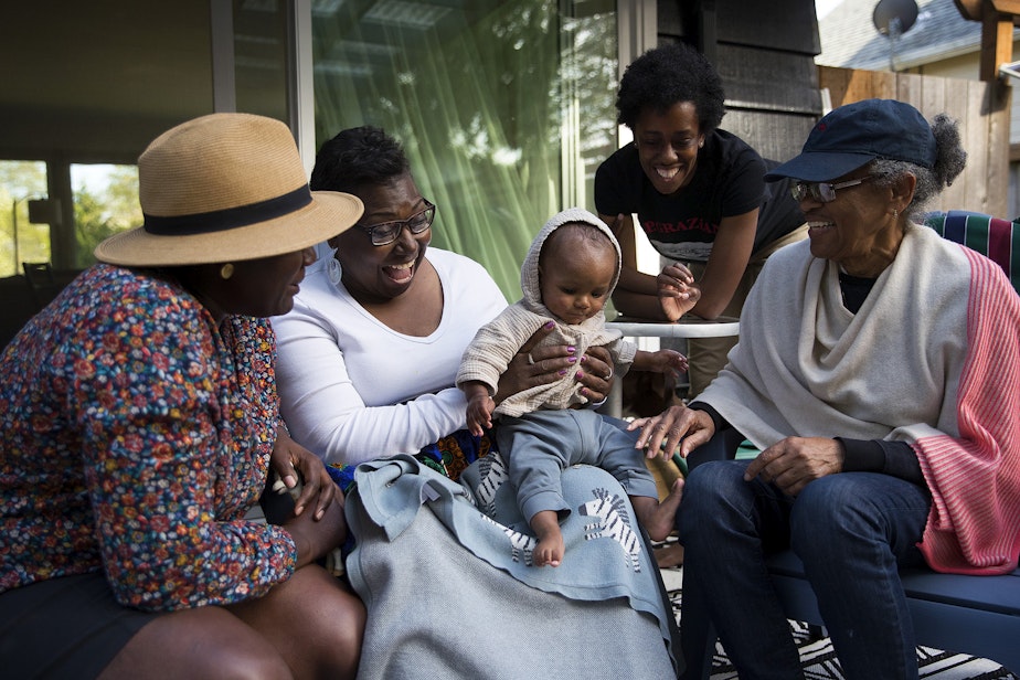 caption: Cassandra Cast, second from left, smiles while holding her 9-month-old grandson, Zoli Rae, next to her daughter, LaTriece Arthur, left, daughter-in-law Christina Arthur, and Christina's mom, Barbara Arthur, right, on Monday, April 19, 2021, at LaTriece and Christina Arthur's home on Vashon Island. Cassandra Cast and Barbara Arthur traveled from Boston and Atlanta, respectively, to meet their grandson Zoli Rae for the first time. 