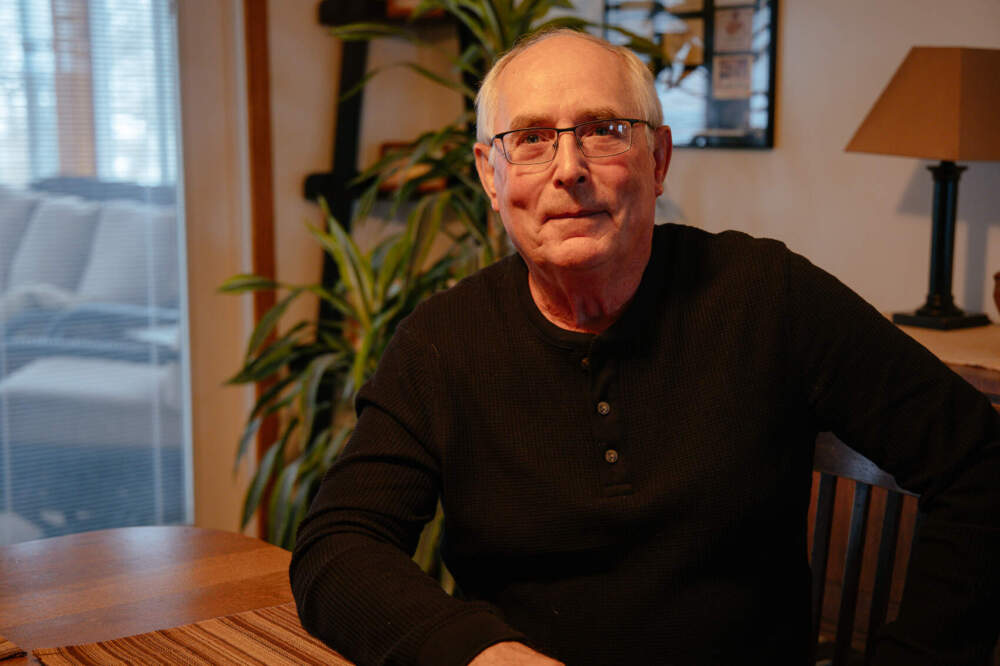 caption: Doug Fuller sits at his dining room table in the middle of his nearly 1,000-acre corn and soybean farm. (Madeleine Charis King/Iowa Public Radio)