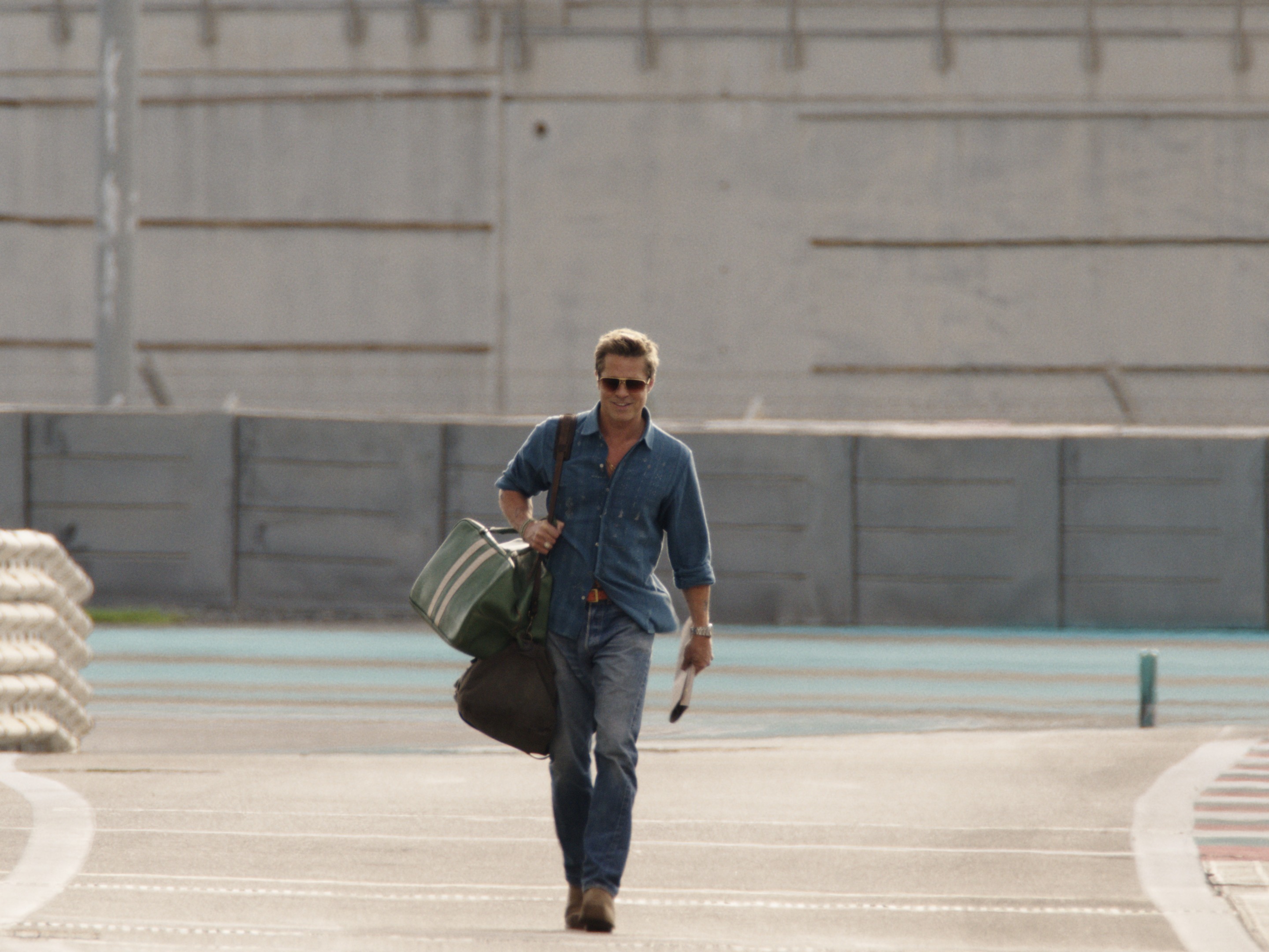 caption: Brad Pitt plays veteran race car driver Sonny Hayes in <em>F1.</em>