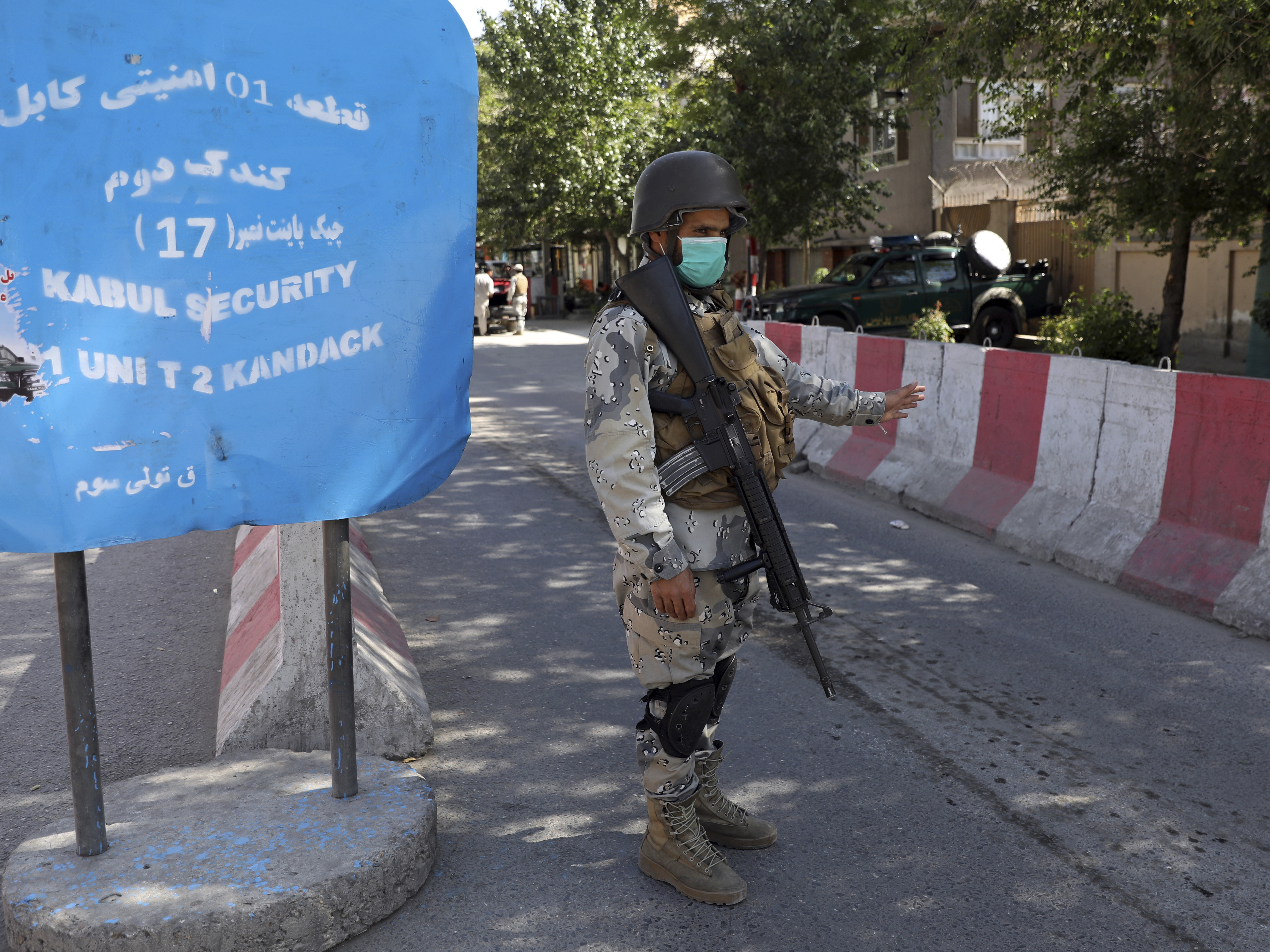 caption: Afghan security personnel guard Kabul's Green Zone, which houses embassies, in May. An additional 3,000 U.S. troops are heading to Afghanistan to assist with evacuation efforts, according to the Pentagon.