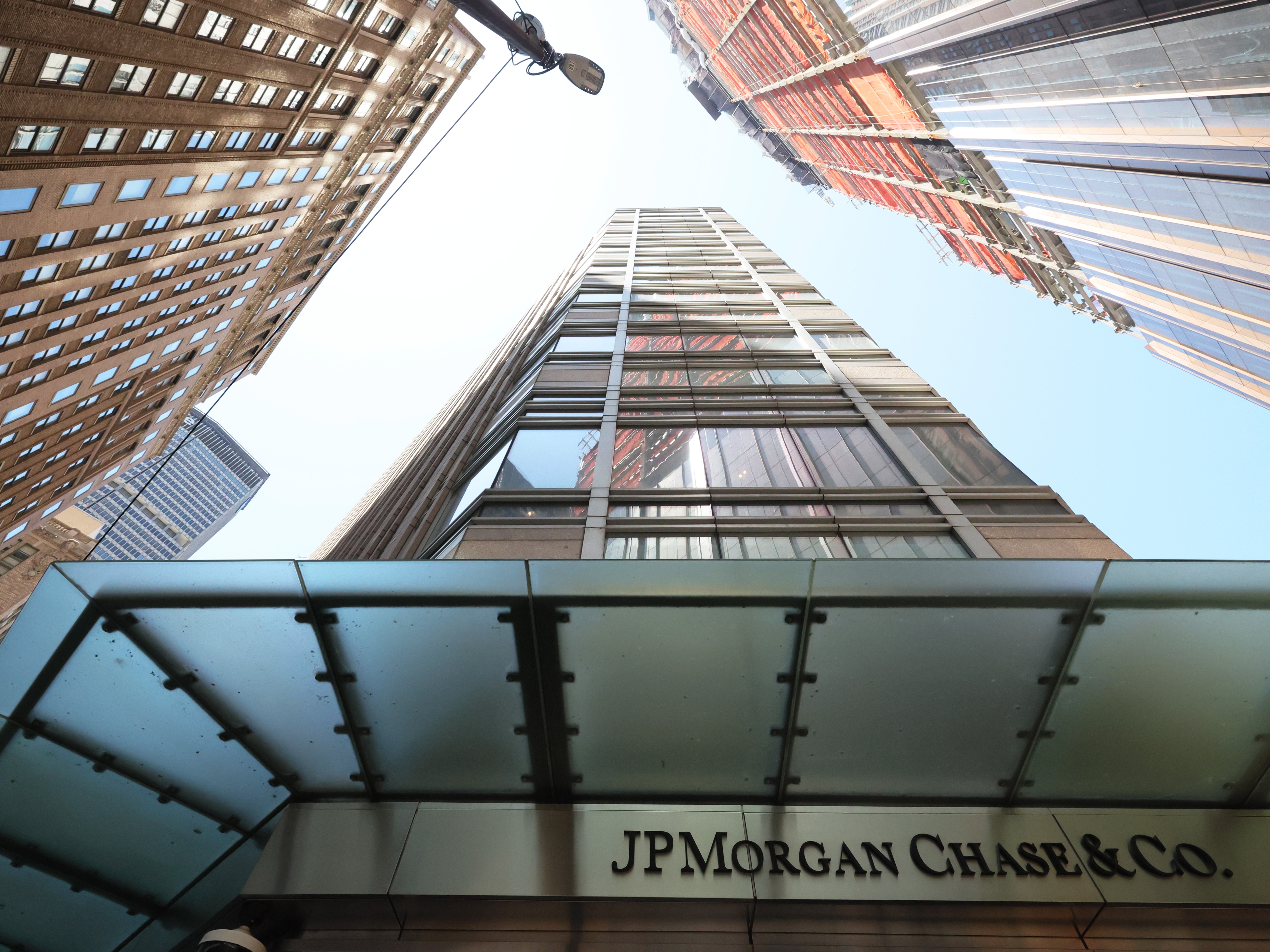 caption: The JPMorgan Chase headquarters building is seen in New York City. The banking giant is filing lawsuits against customers who exploited a viral technical glitch this summer that allowed people to pull huge amounts from Chase ATMs.