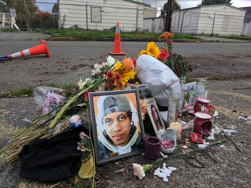 caption: Friends leave flowers near the spot where Daniel Alberto was shot in North Seattle