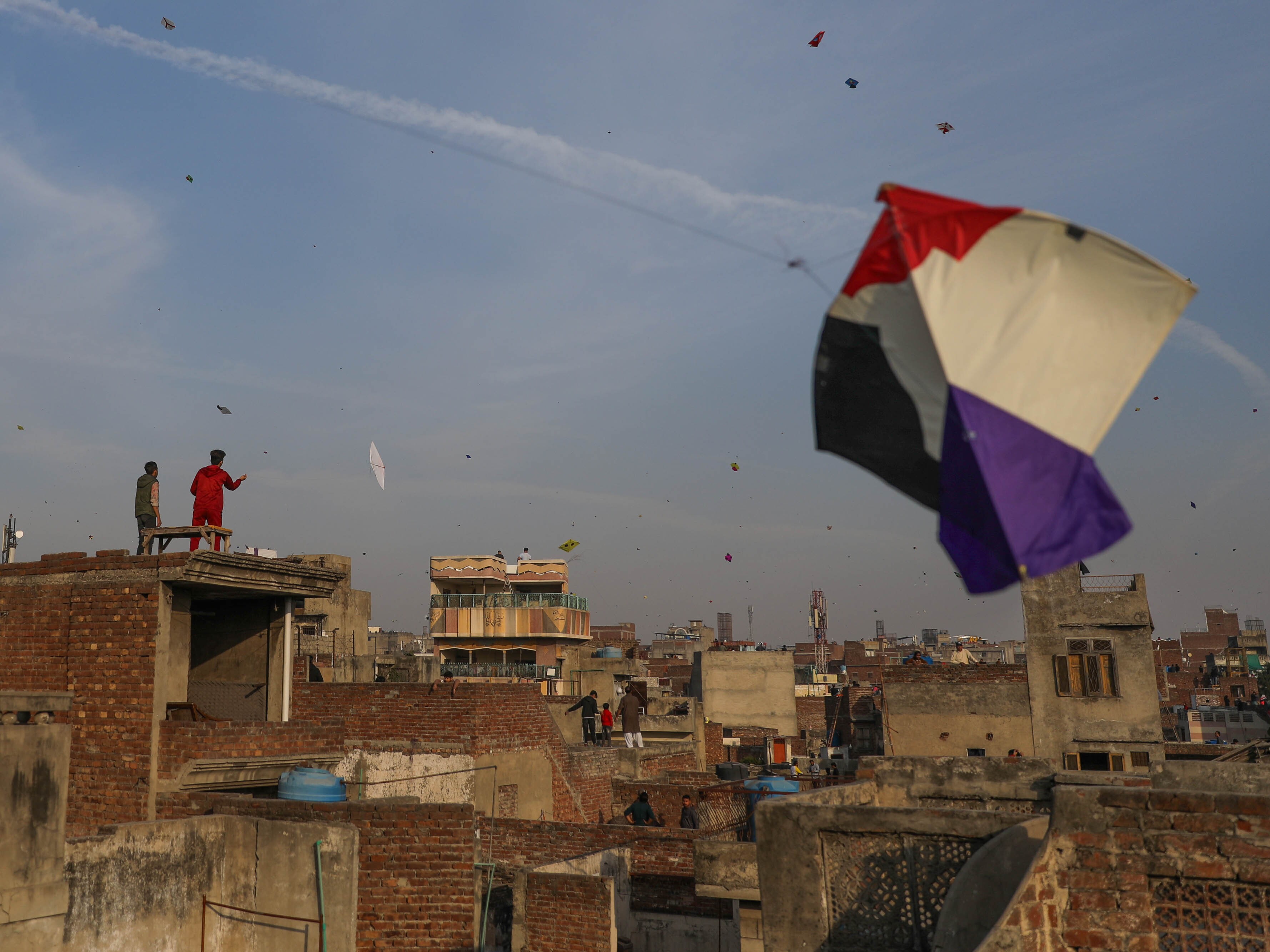 caption: People gather on rooftops in Lahore's Old City to fly kites during Basant.