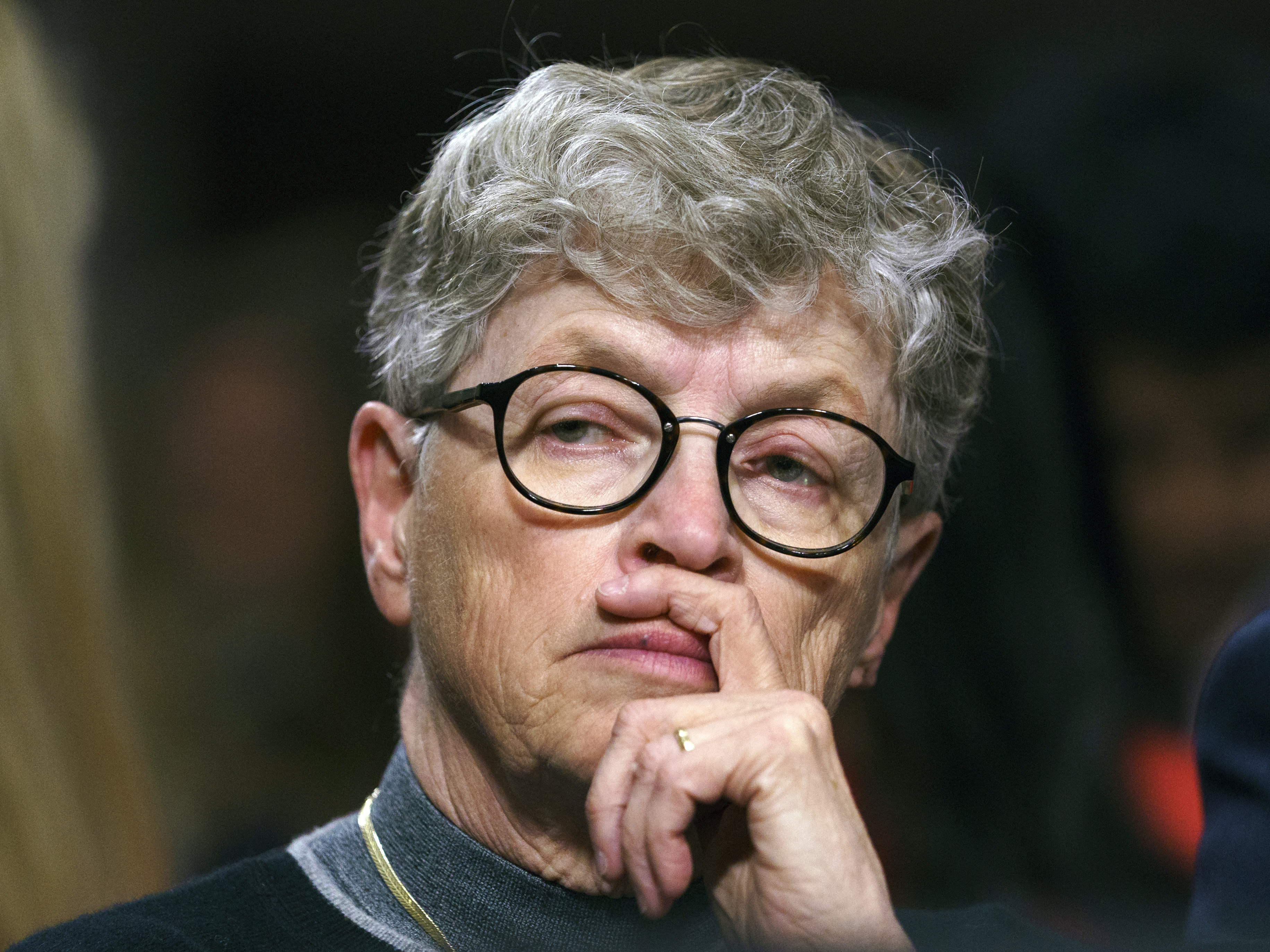 caption: Former Michigan State President Lou Anna Simon pauses before testifying during a 2018 Senate subcommittee hearing in Washington, D.C., on preventing abuse in Olympic and amateur athletics.
