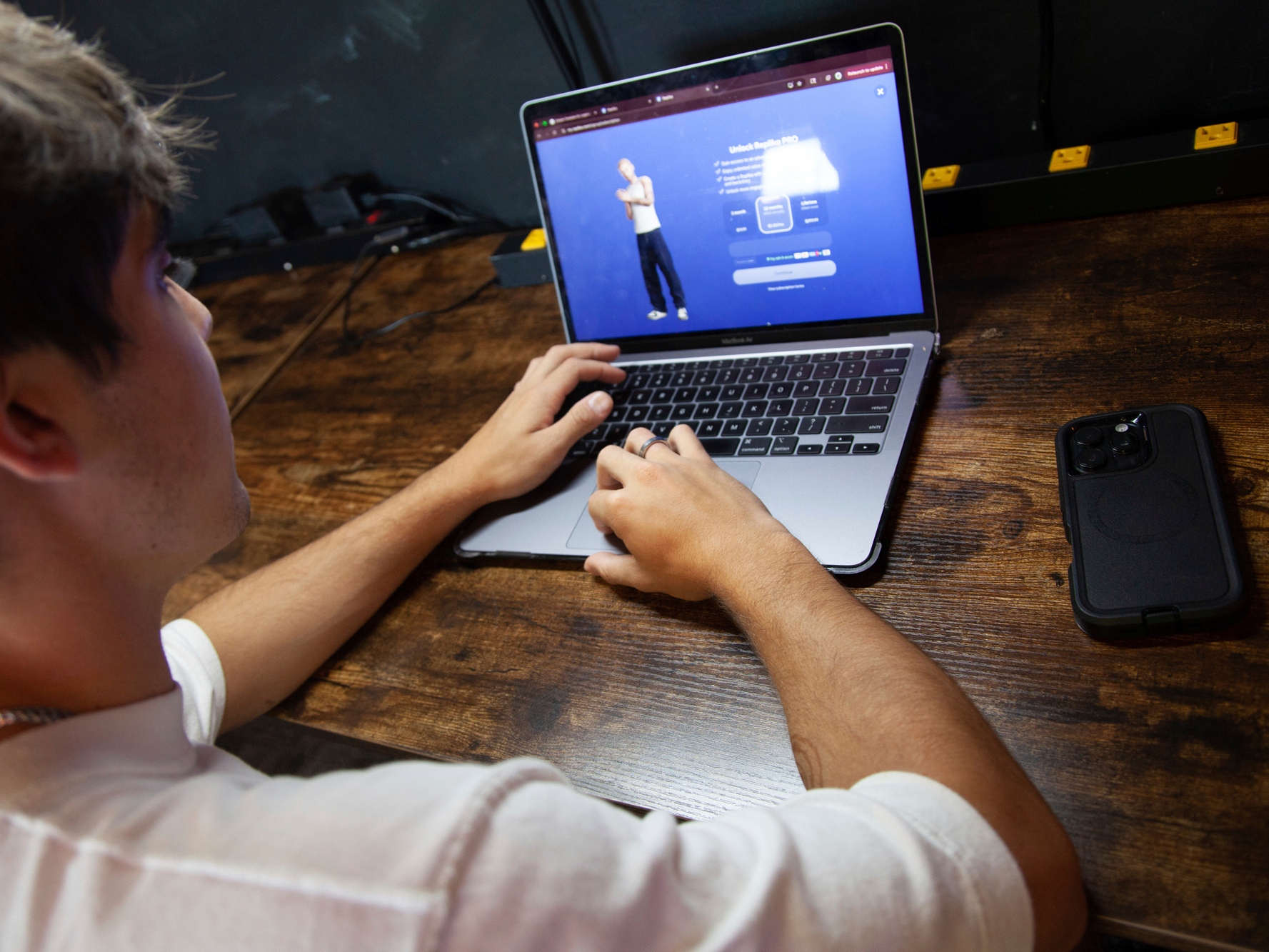 caption: Bruce Perry, 17, demonstrates the possibilities of artificial intelligence by creating an AI companion on Character.AI, July 15, 2025, in Russellville, Ark.