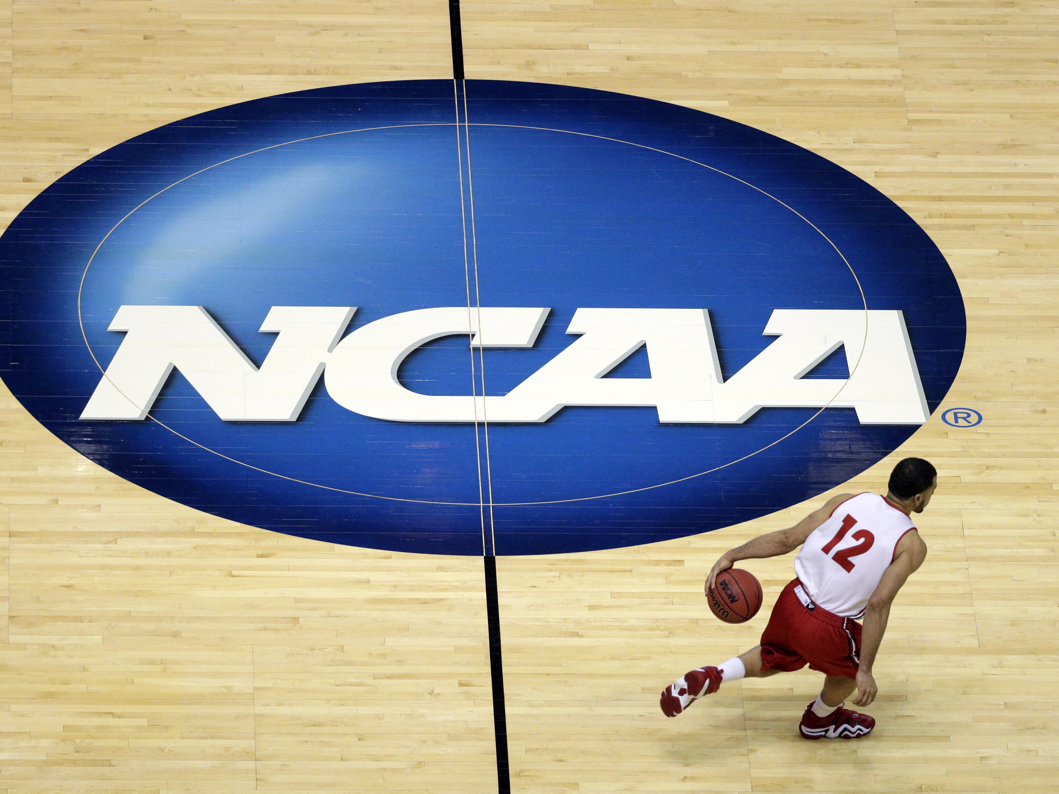 caption: Starting this fall, NCAA Division I schools will be able to pay players directly up to a salary cap of $20.5 million.