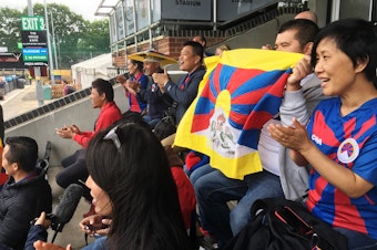 caption: Tibetans cheer on a Tibetan team at a soccer tournament in London. Fans say they were pleased and surprised that the tournament organizers didn't succumb to pressure from potential sponsors and dump the Tibetan team to avoid angering the Chinese government.